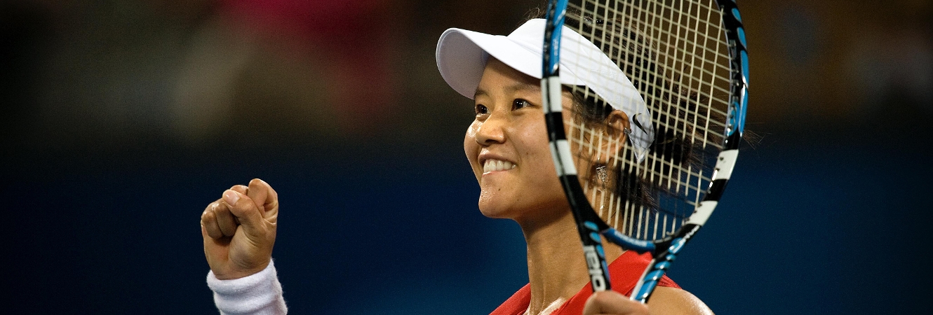 A tennis player smiling after competition